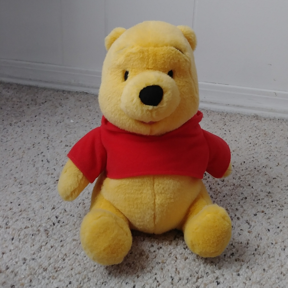 Winnie the Pooh taking plush toy